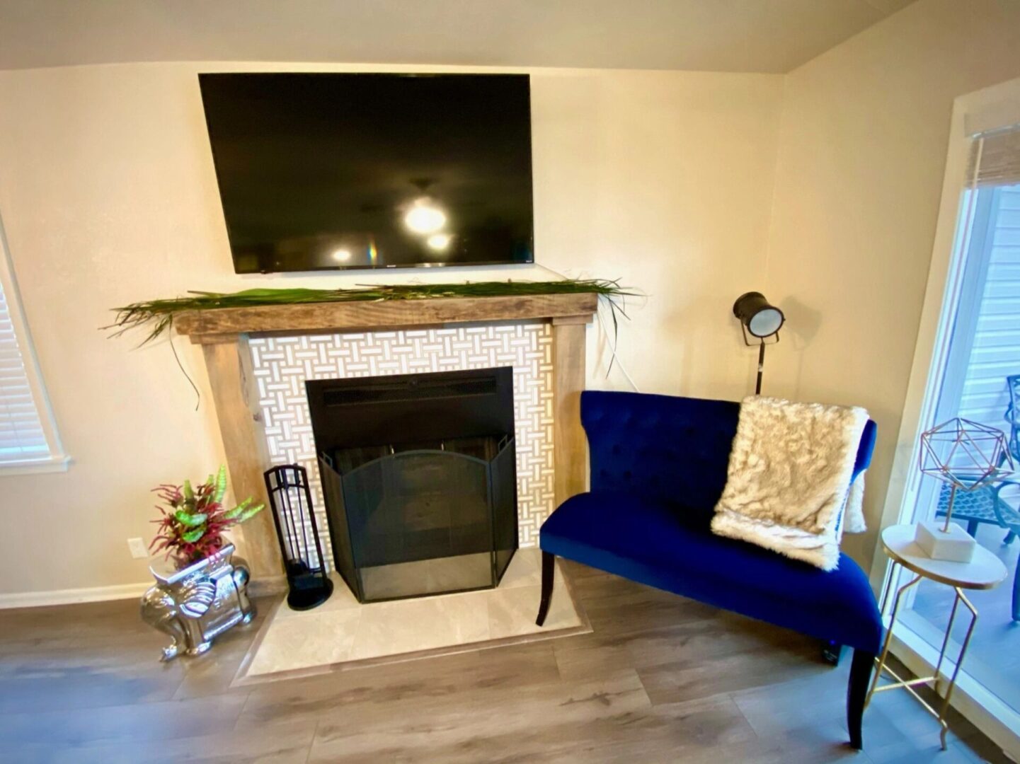 A blue chair and fireplace in the living room
